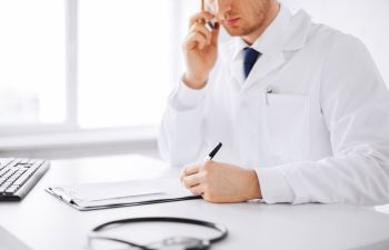 doctor talking on a phone and taking notes