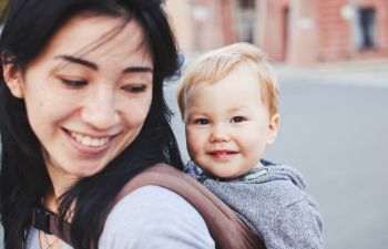 Hapy woman carrying a baby on her back