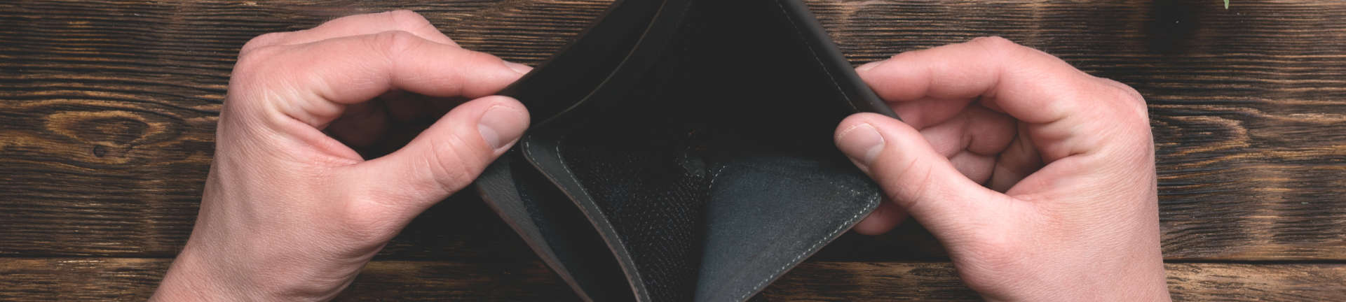 a person showing an empty wallet