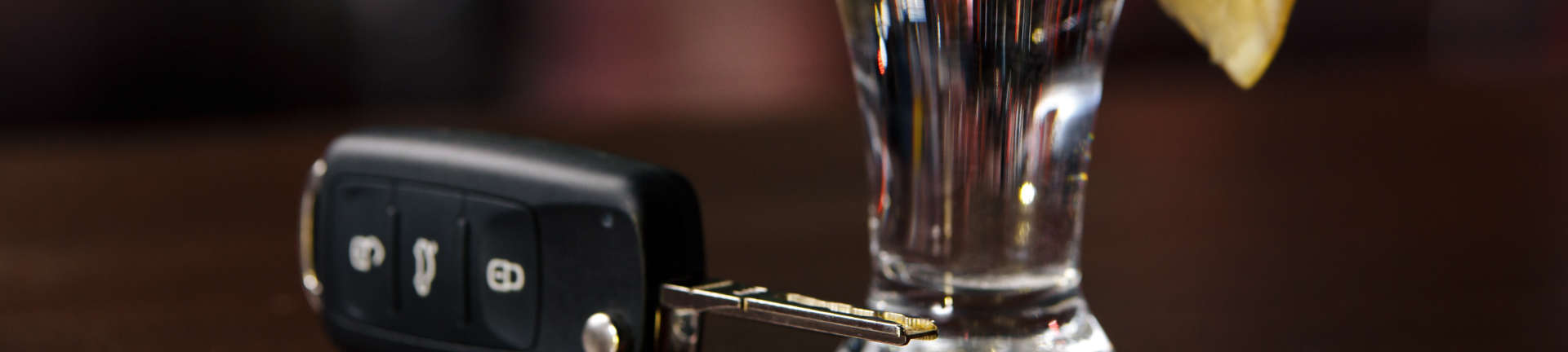 Car key and a glass with drink