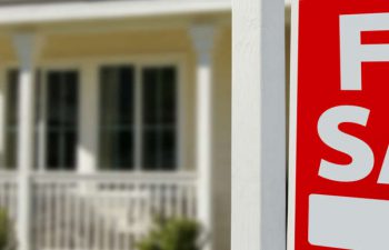 For sale sign in front of a house