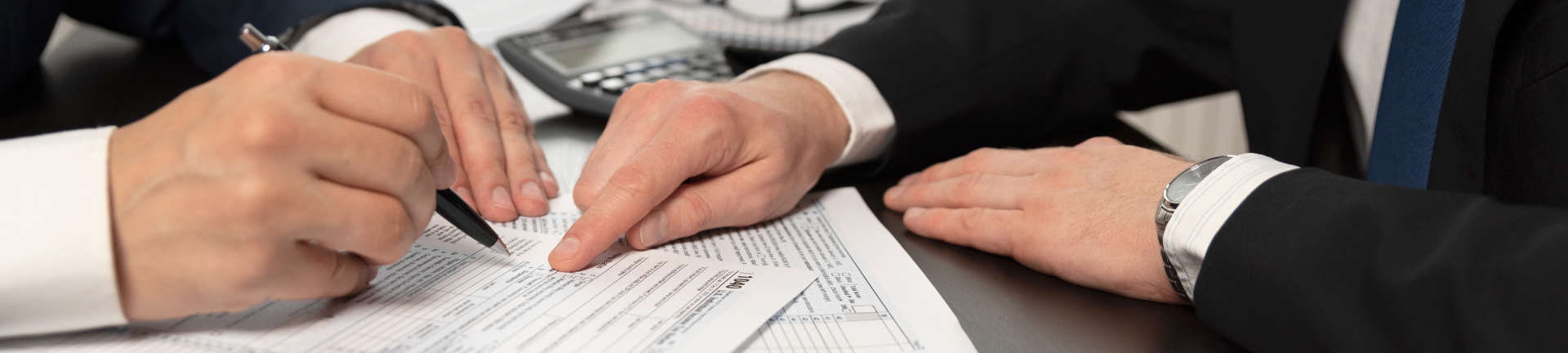 A lawyer advising a businessman who is filling out documents