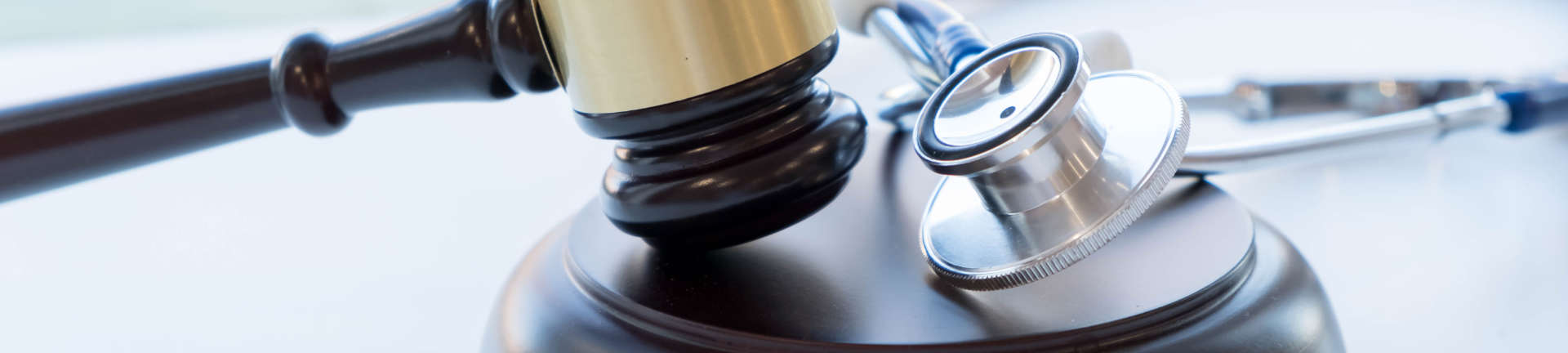 Judge's gavel and a stethoscope on a desk of Medical Malpractice Attorney Augusta GA