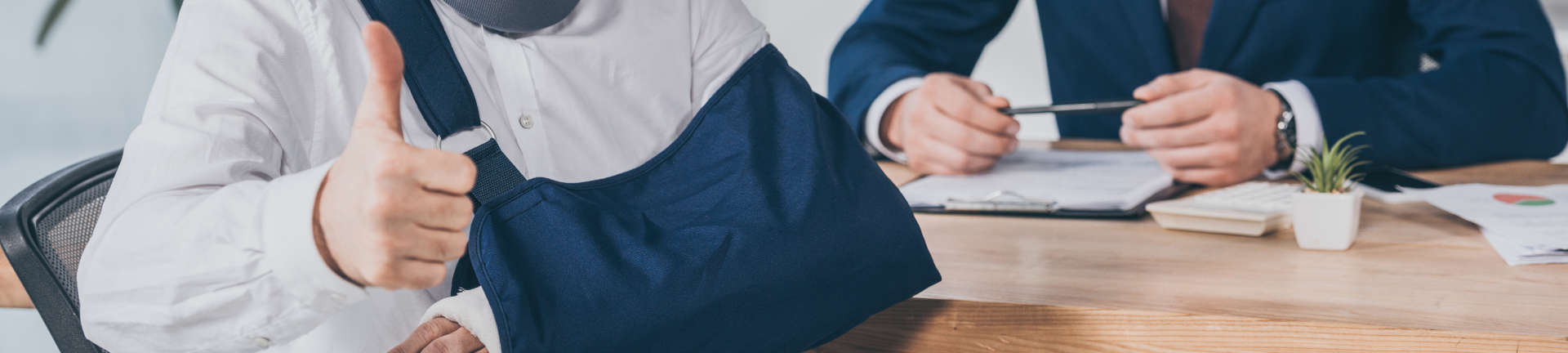 Person with a broken arm showing a thumb up after a meeting with a Workers' Compensation lawyer Augusta GA