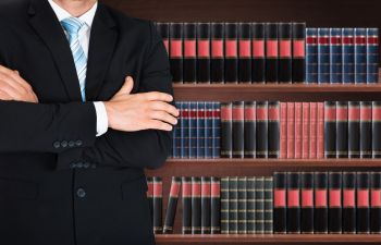 Lawyer in front of shelvew with legal books Augusta GA